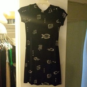 Black dress with white Aztec like designs on it.